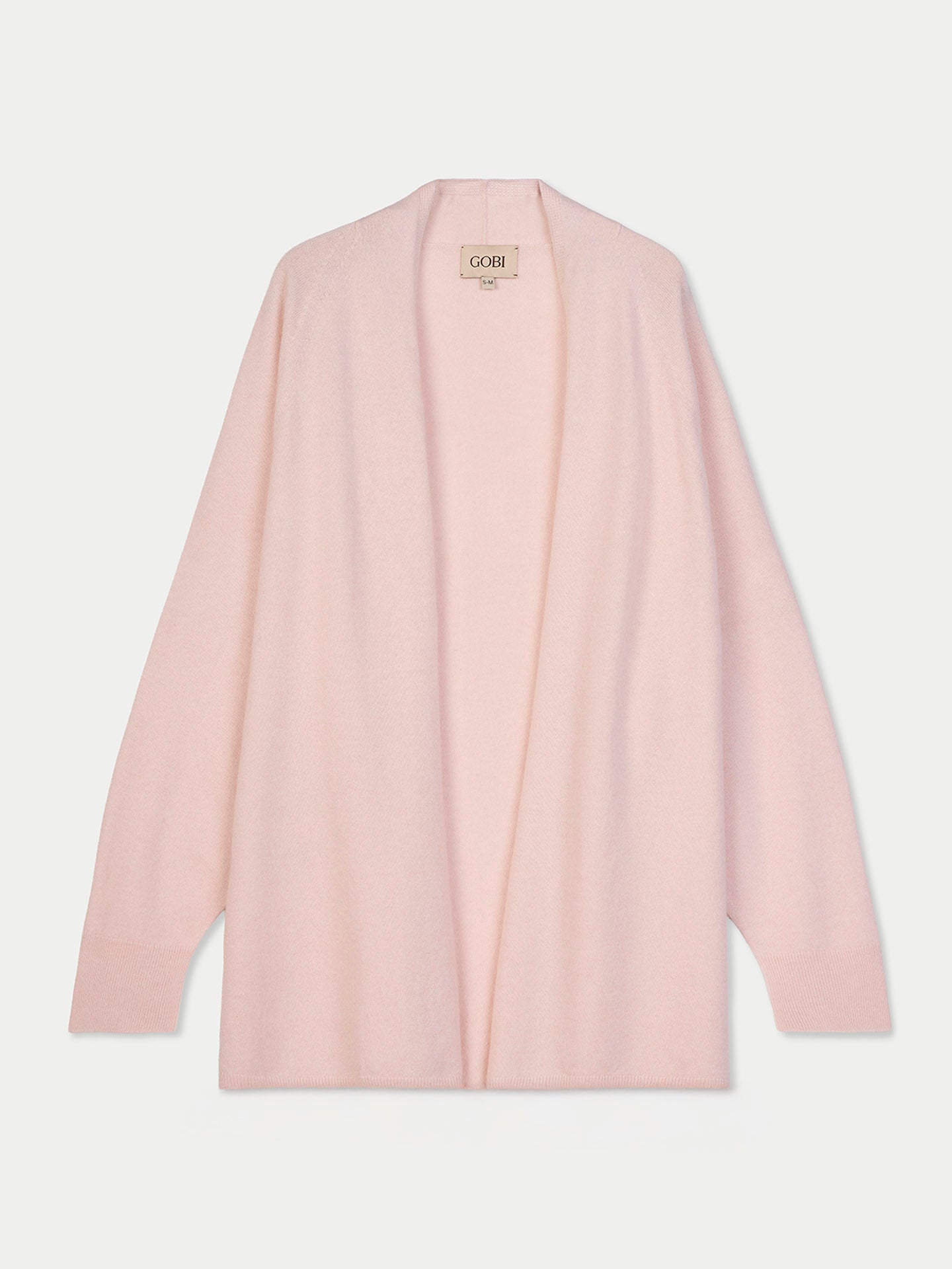 Vue de face d'un cardigan ouvert rose pâle sur fond gris clair. #color_peach-blush