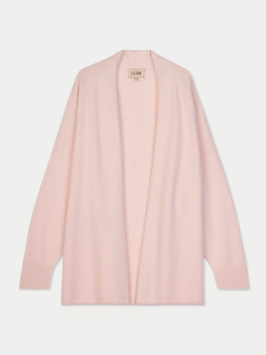 Vue de face d'un cardigan ouvert rose pâle sur fond gris clair. #color_peach-blush