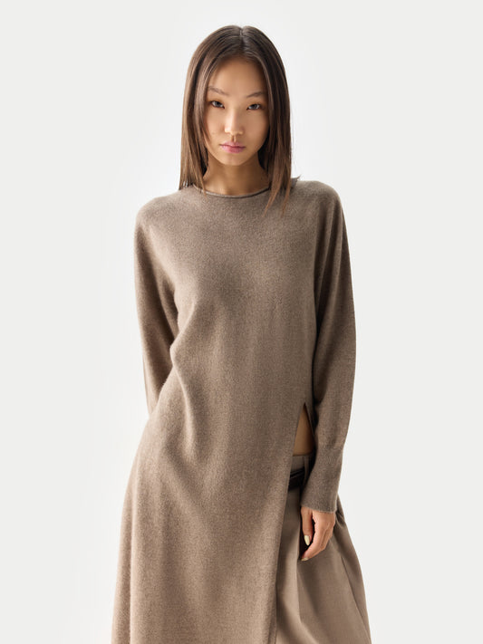 Gros plan sur une robe beige à col rond, manches longues et fente latérale, sur fond gris clair. #color_taupe